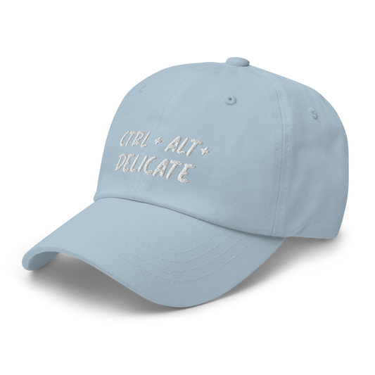 Embroidered dad hat with "Ctrl + Alt + Delicate" design; tech-inspired fashion statement with adjustable strap for a perfect fit, ideal for expressing unique style and humor. Available in Spruce, Khaki, Stone,  Pink, Light Blue